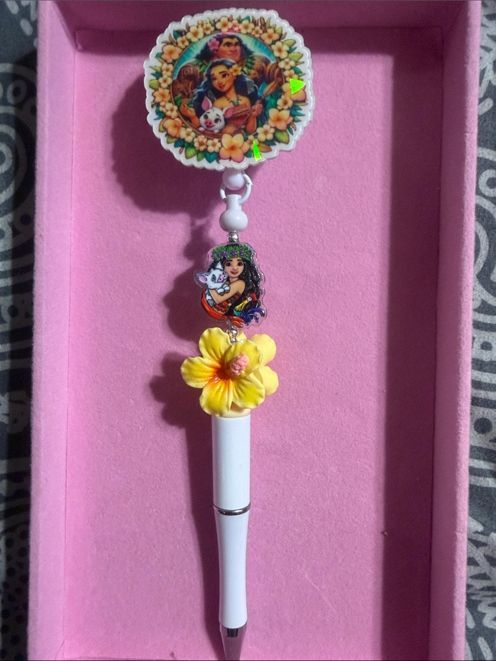 Moana beaded badge reel with retractable pen.